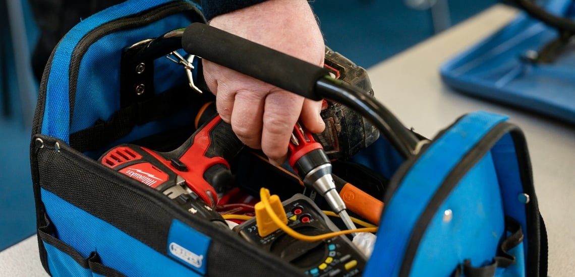 A close up of a toolbox. It's important to factor in equipment costs when budgeting for school caretakers.
