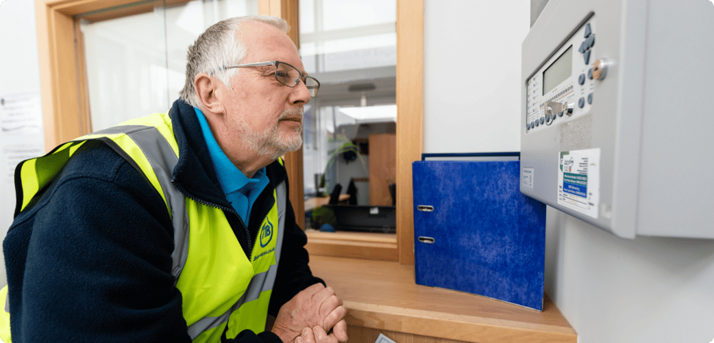 Jeff checks an alarm while wearing a TIB high vis