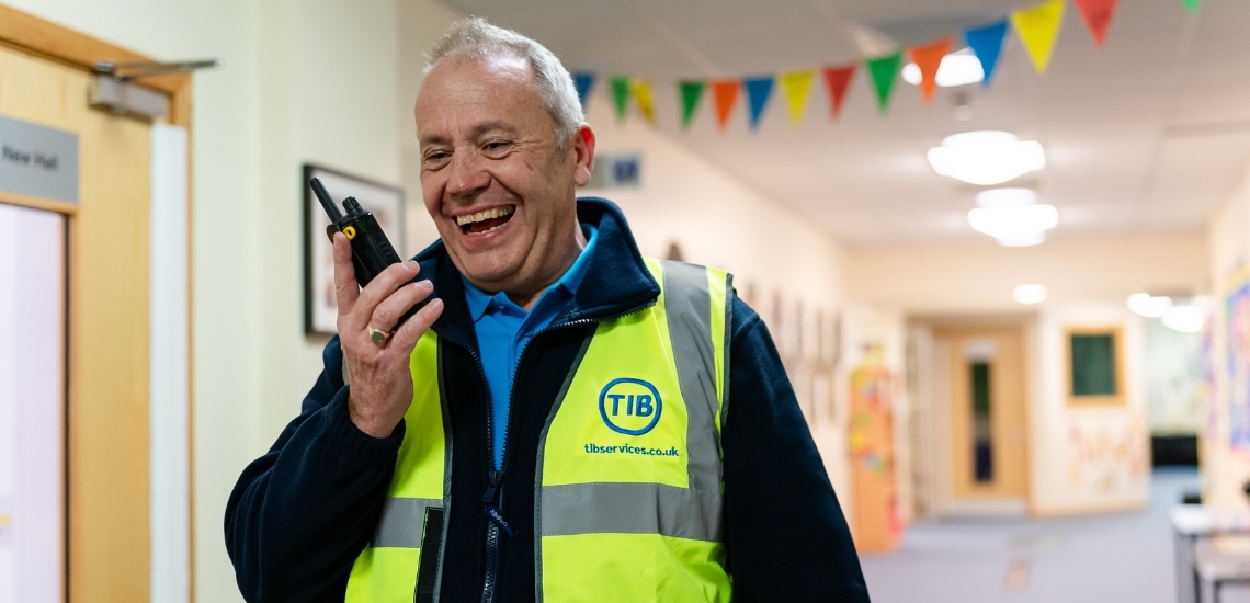 A smiling TIB Services operative showing the value of effective budgeting for hiring school caretakers