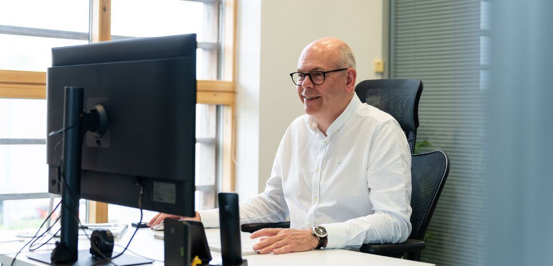 A TIB Services Vetting & Safeguarding Specialist interviews a school caretaker via video call