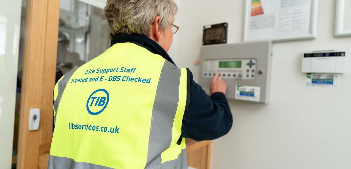 A TIB Services caretaker checks a school alarm