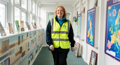 A TIB operative walks through a school corridor